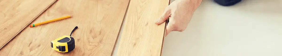 A professional installing wood flooring in Riverside, CA