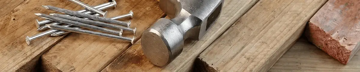 Hammer and nails on hardwood flooring boards in Riverside, CA