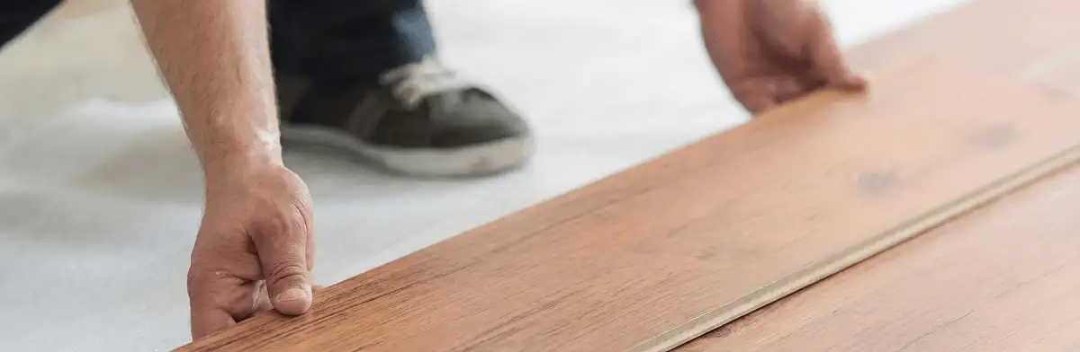 A professional installing laminate flooring in Riverside, CA